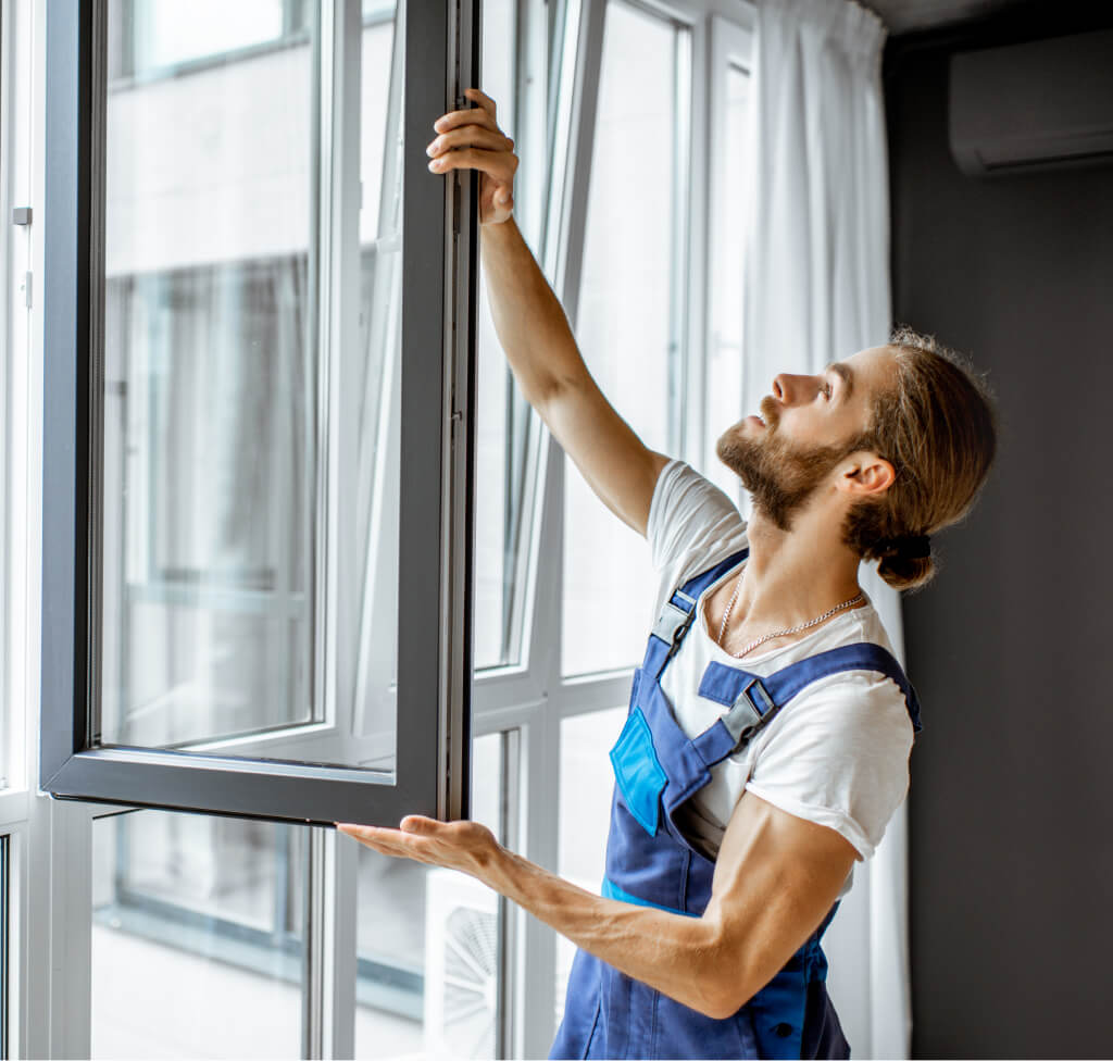 Window frame repairs service: Man adjusting a window. Professional window services for your home.