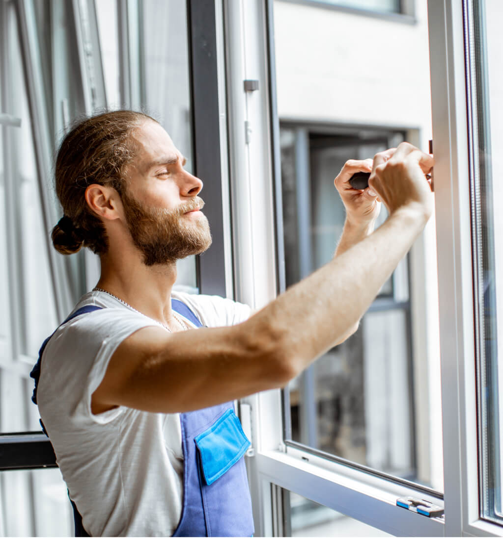 Window repair services: Technician repairing a white window frame, ensuring optimal performance.
